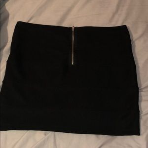 Black mini skirt with a zipper.